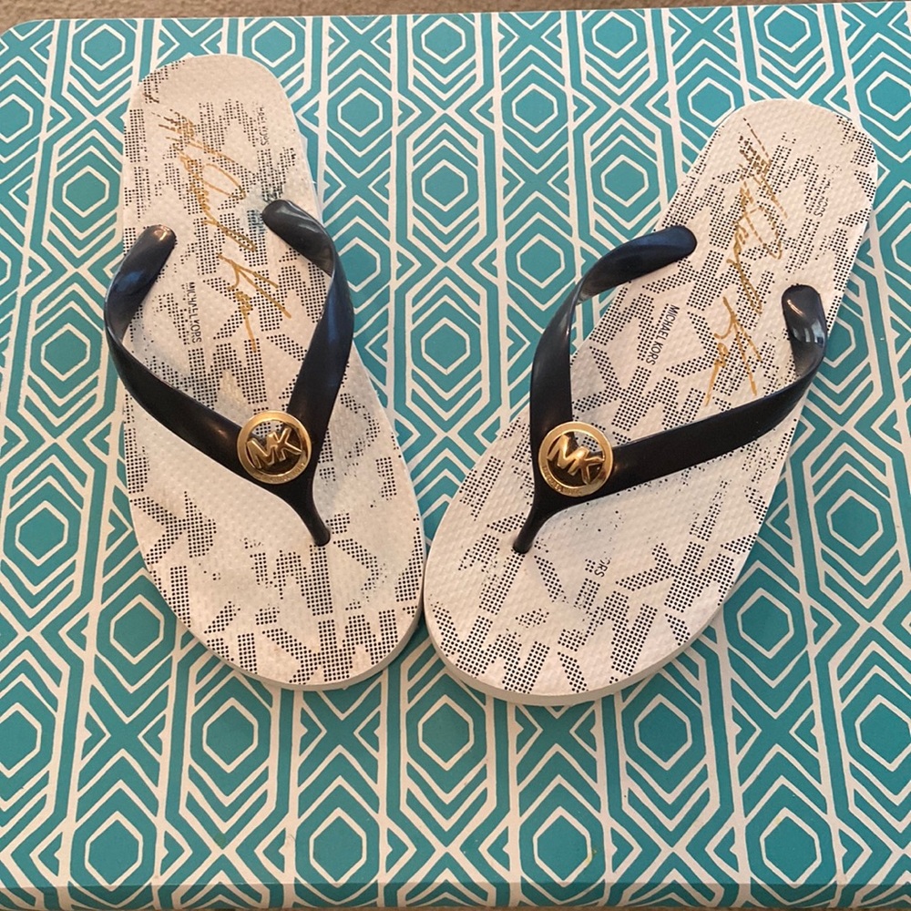 Michael Kors, thongs, with gold accent MK emblem on the top.